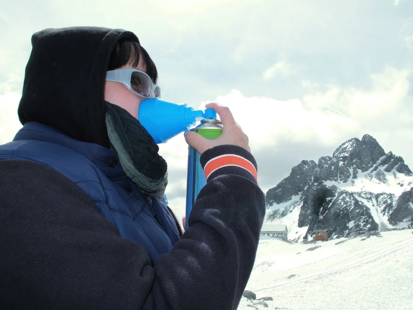Trekker using an oxygen mask at high altitude in the Nepal Himalayas to manage altitude sickness symptoms