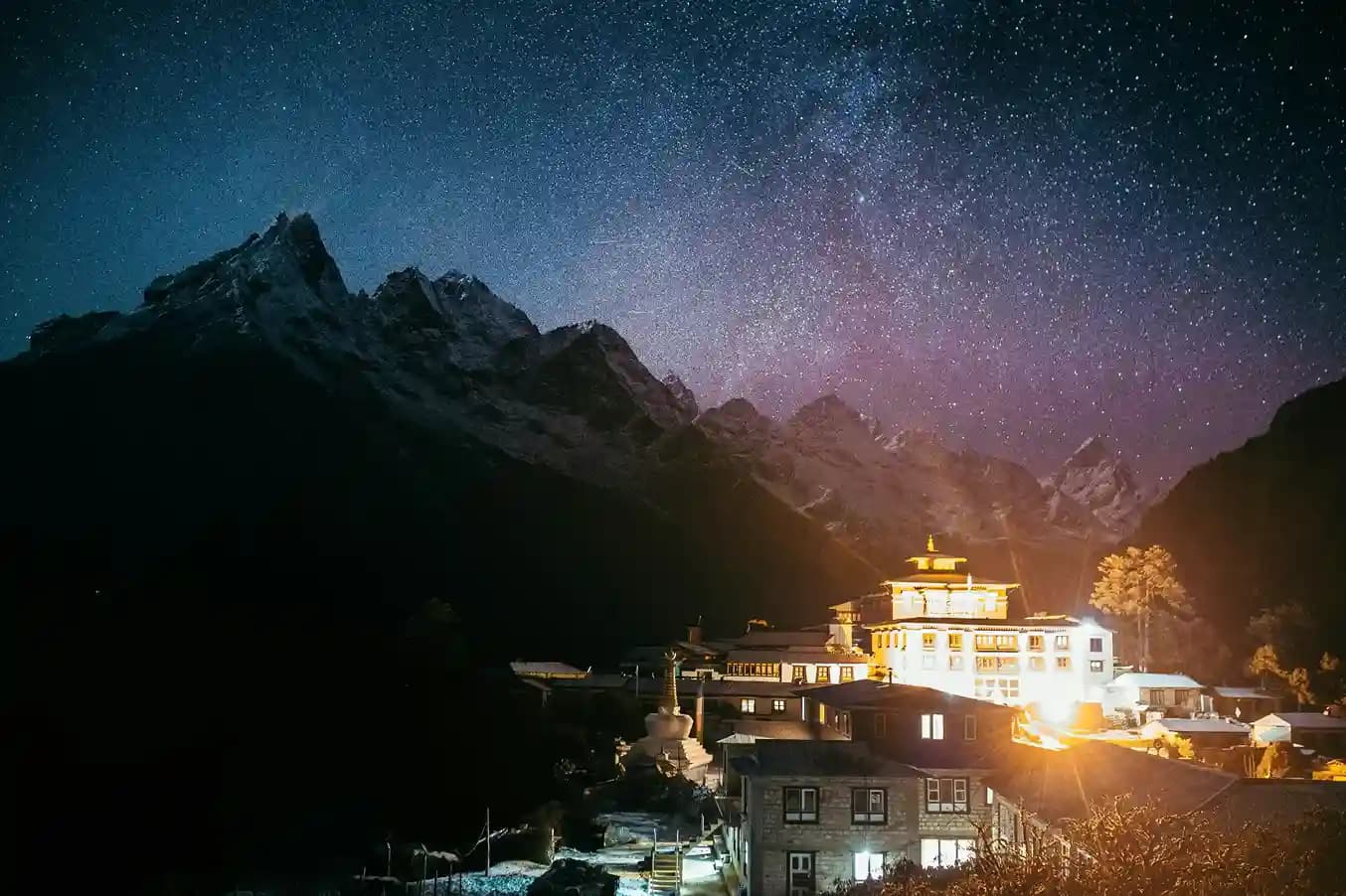 The intricate colorful paintings and architecture of the Tengboche Monastery against a backdrop of the majestic Ama Dablam peak.
